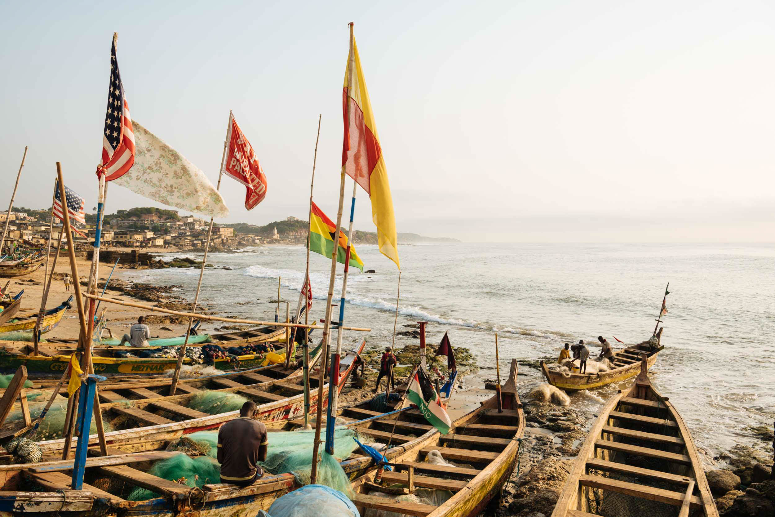 fishing-boats-flags-shore-cape-coast-ghana-africa