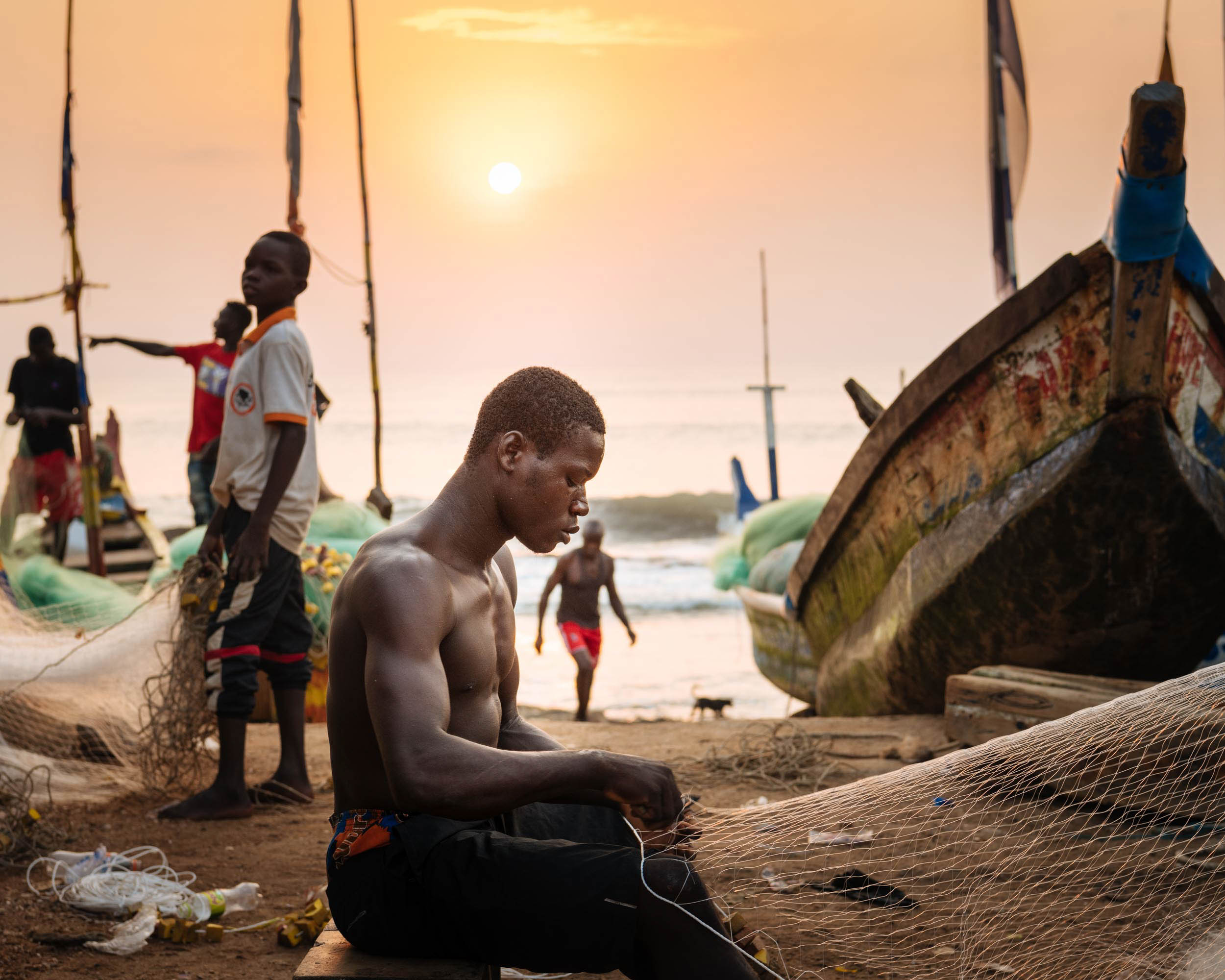 sunrise-fisherman-fixing-nets-dawn-cape-coast-ghana-africa